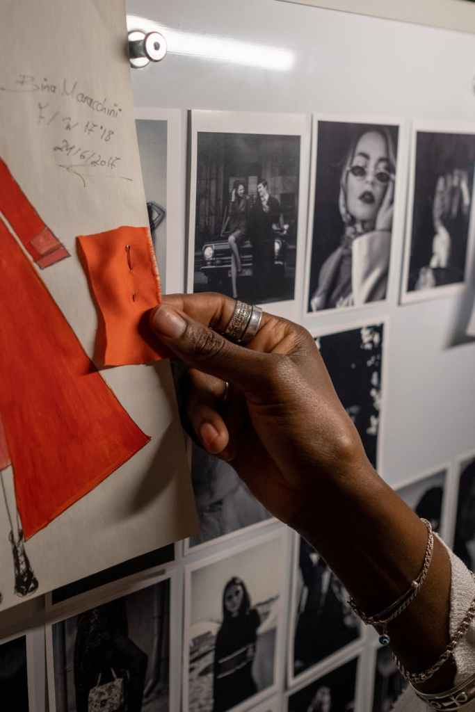 hand touching a orange fabric watch 