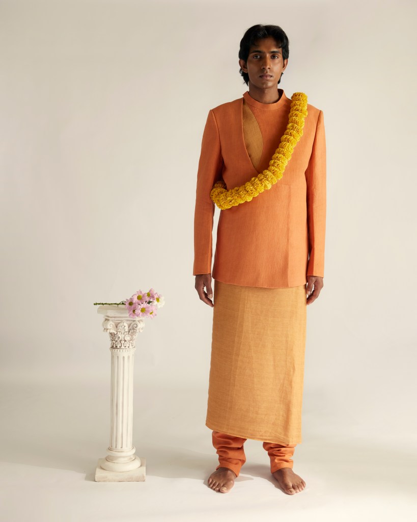 Model in orange jacket and yellow skirt