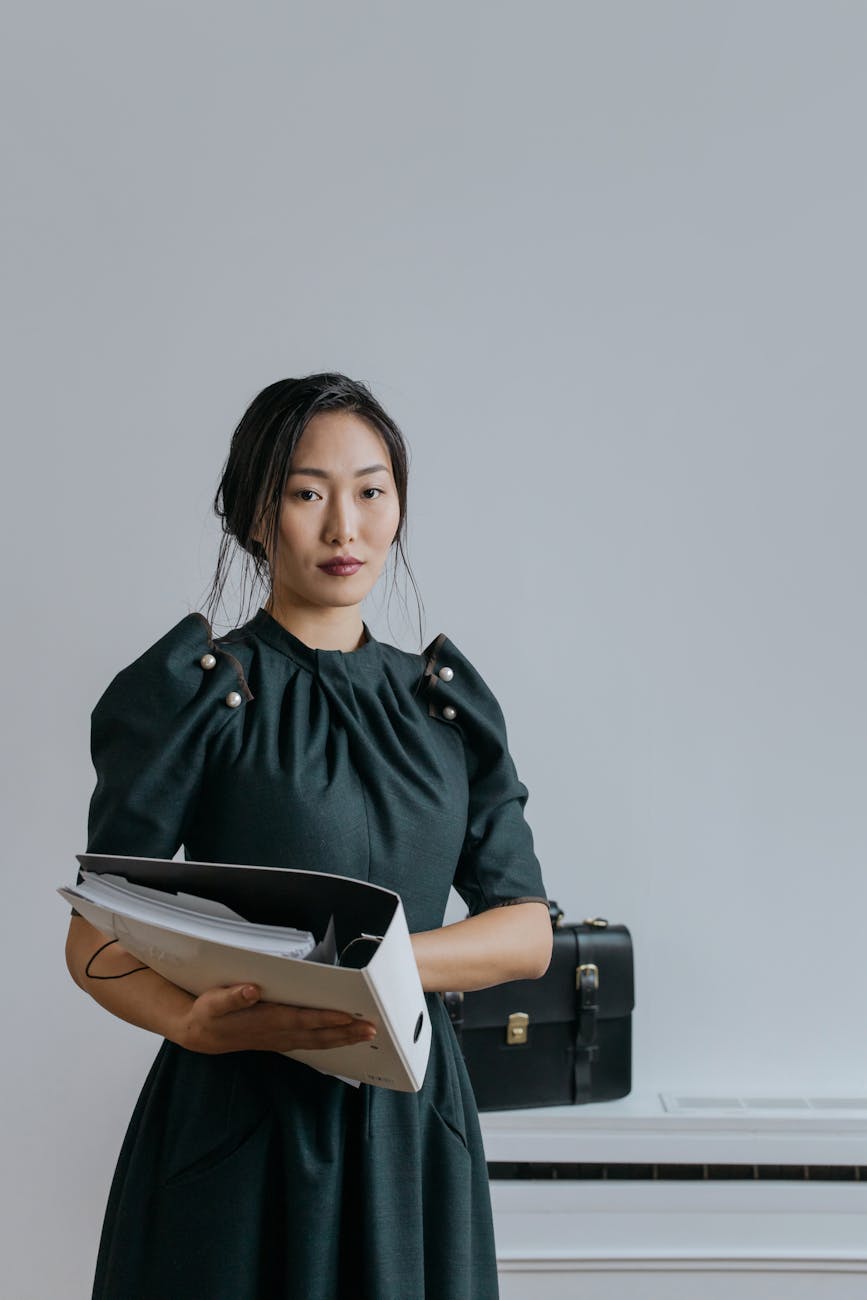 Image of a fashion design student holding a portfolio